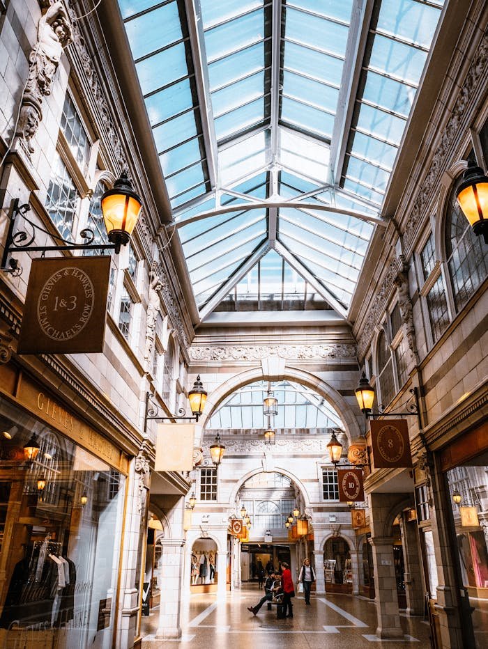 Bright and modern shopping arcade in Chester, UK with a glass ceiling.